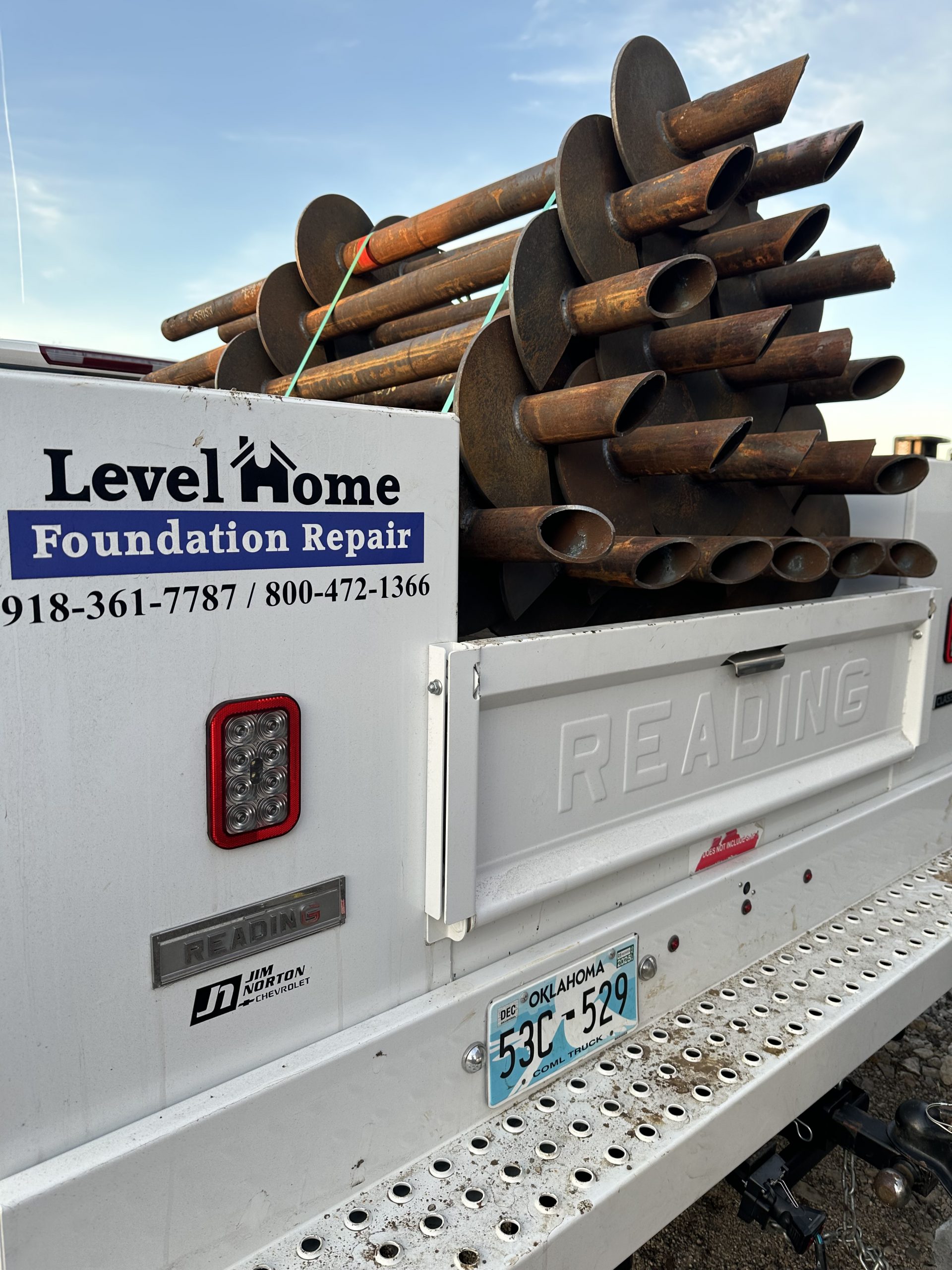 Steel pier installation in progress at a Tulsa Oklahoma home by Level Home Foundation Repair
