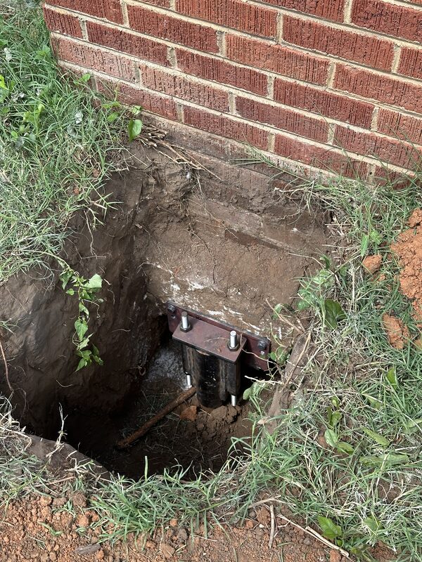 steel pier installed against brick foundation wall Tulsa Oklahoma Level Home Foundation Repair