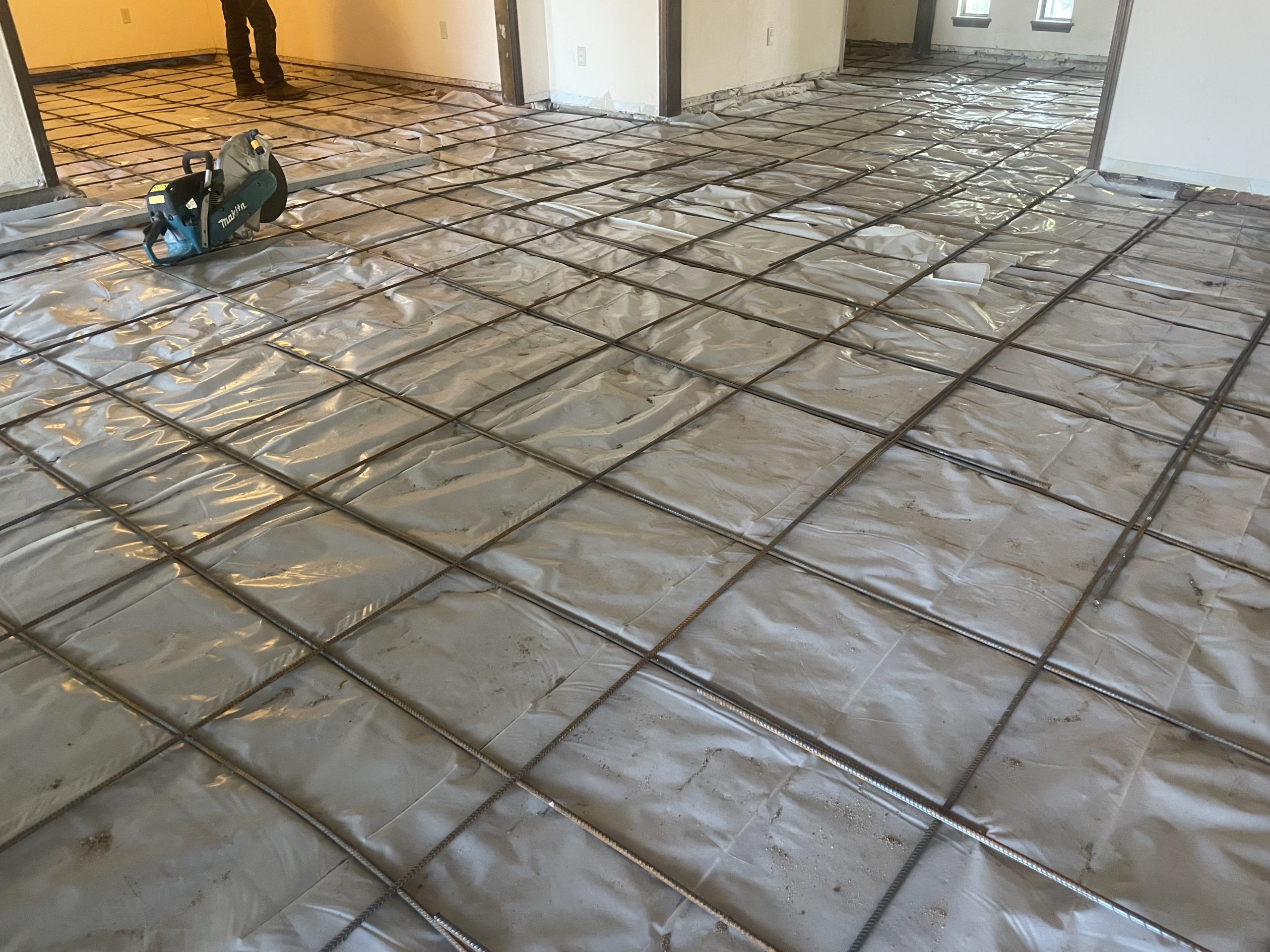 Rebar grid and vapor barrier laid for interior slab replacement by Level Home Foundation Repair in Tulsa