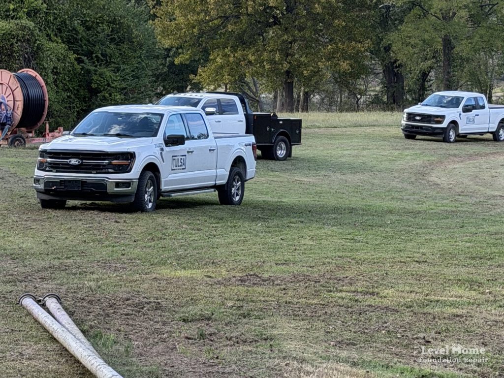 City of Tulsa trucks parked on the grounds of a water treatment facility during a retention pond leak repair by Level Home