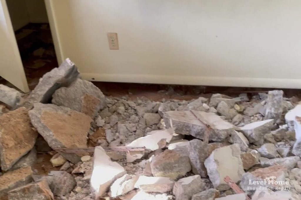 Broken pieces of an unreinforced interior concrete slab removed during a full interior slab replacement by Level Home Foundation Repair, one of several foundation repair methods for severe settlement