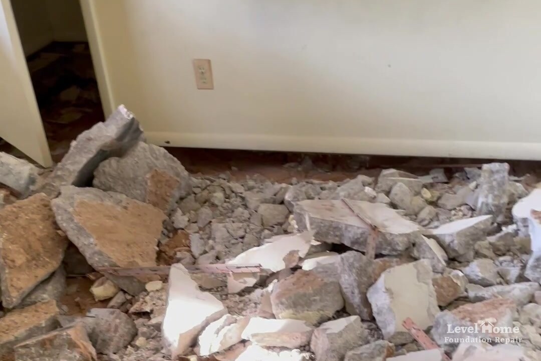 Broken pieces of an unreinforced interior concrete slab removed during a full interior slab replacement by Level Home Foundation Repair, one of several foundation repair methods for severe settlement