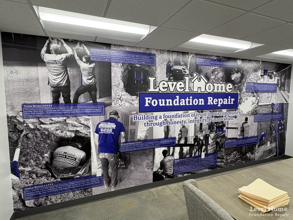 Level Home Foundation Repair office wall mural showing team at work with five star customer reviews and company mission statement building a foundation of trust in Tulsa Oklahoma